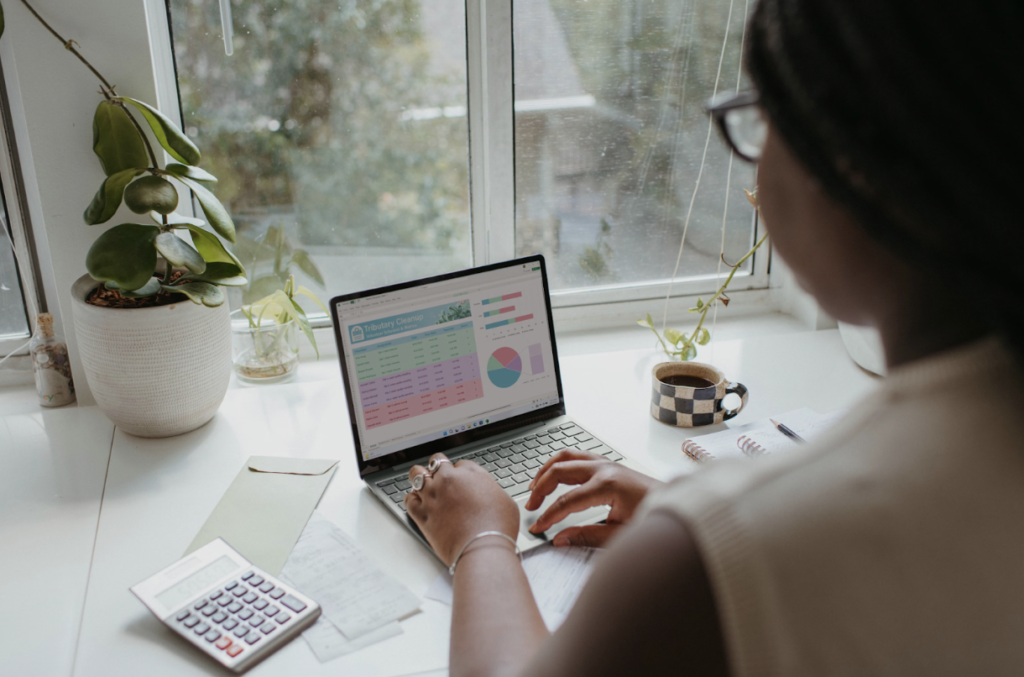 Woman Sitting at a Desk and Managing Business Finances